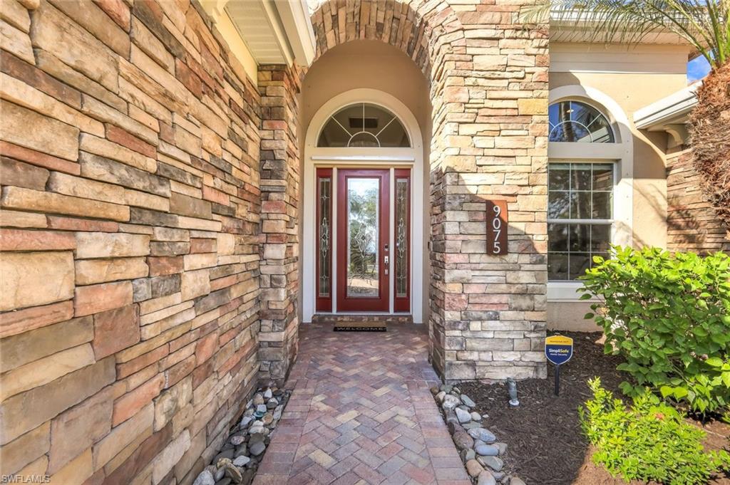 9075 Breakwater Drive Naples, FL 34120 - Photo 5 of 48 a front view of a house with large windows