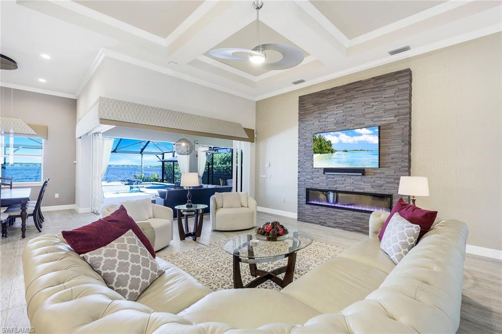 9075 Breakwater Drive Naples, FL 34120 - Photo 7 of 48 a living room with furniture and a flat screen tv