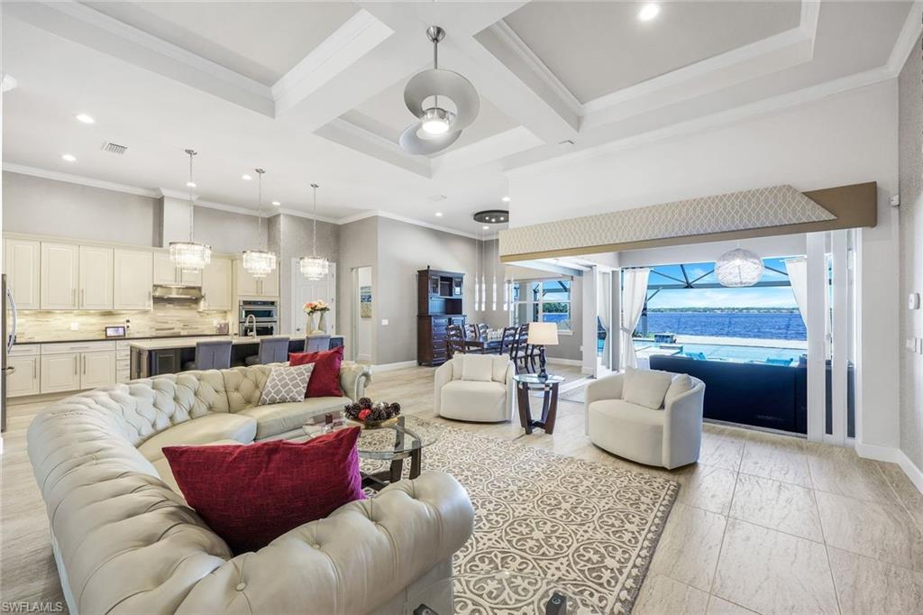 9075 Breakwater Drive Naples, FL 34120 - Photo 8 of 48 a living room with furniture and a large window