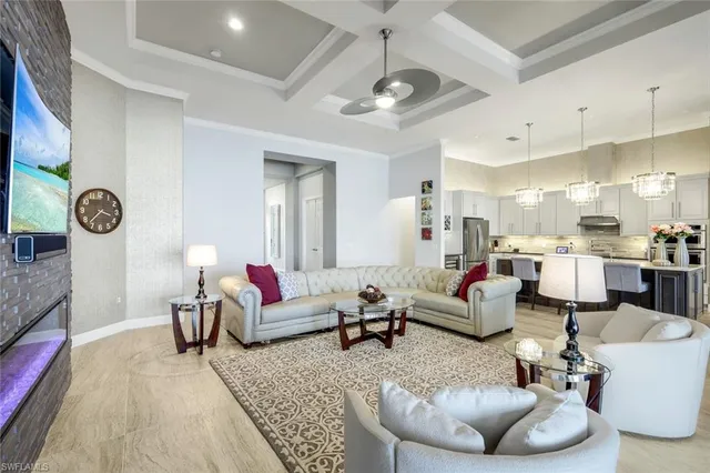 a living room with furniture and kitchen view