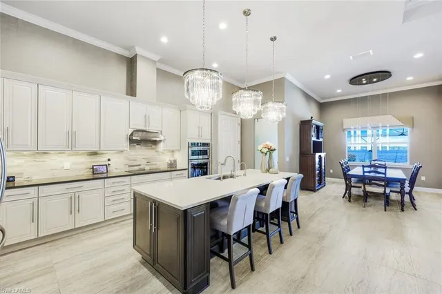 a large kitchen with a table and chairs