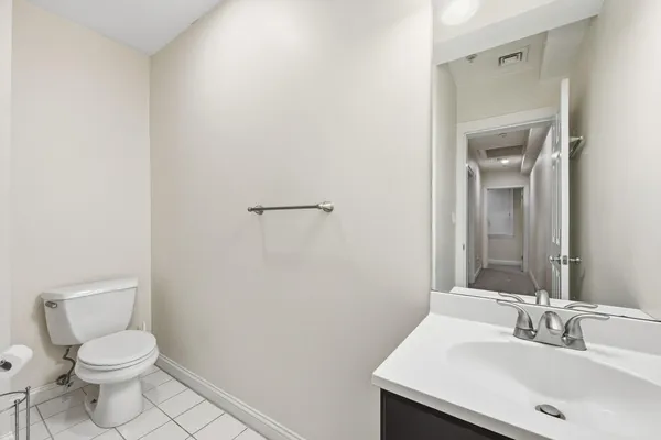 a bathroom with a sink a toilet and mirror