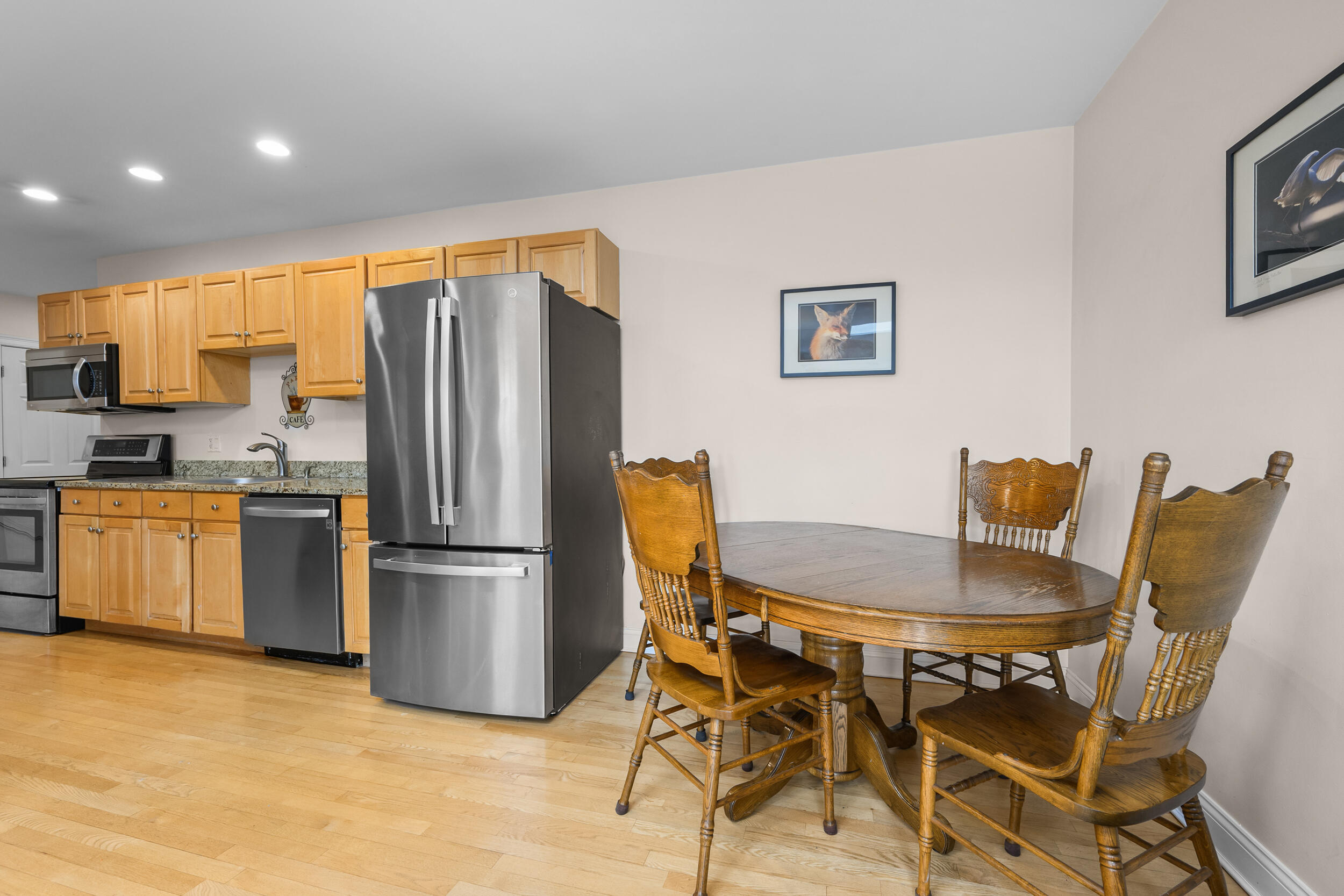 615 Main Street, Unit 3 Hyannis, MA 02601 - Photo 6 of 22 a kitchen with stainless steel appliances granite countertop a dining table and chairs