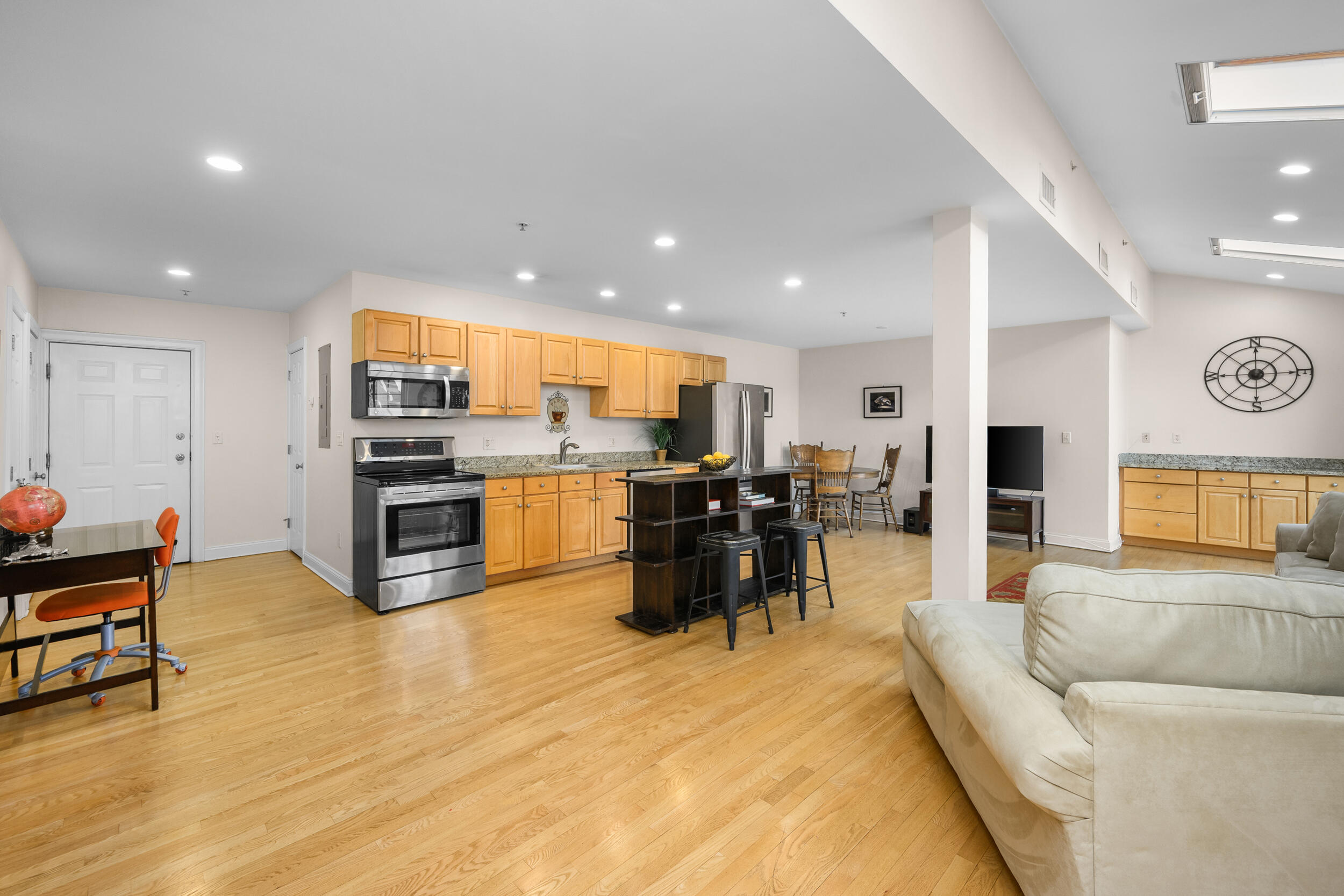 615 Main Street, Unit 3 Hyannis, MA 02601 - Photo 10 of 22 a living room filled with stainless steel appliances kitchen island granite countertop furniture and a dining table with wooden floor