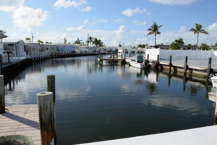 55 Boca Chica Road, Unit 93 Key West, FL 33040 - Photo 19 of 21 a lake view with tables and chairs