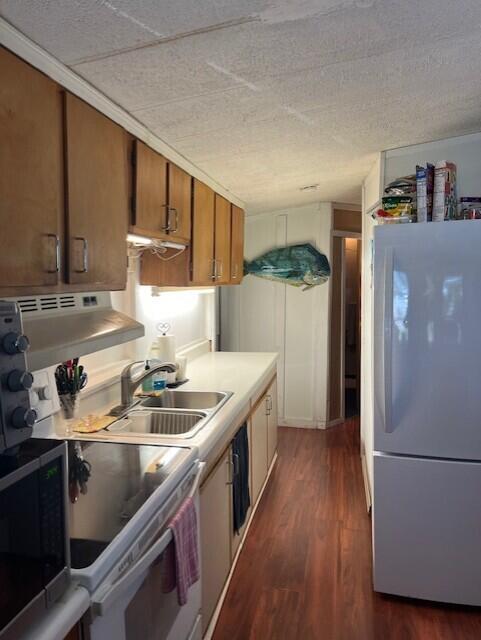 55 Boca Chica Road, Unit 93 Key West, FL 33040 - Photo 6 of 21 a kitchen with a sink a refrigerator and cabinets