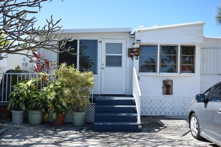 55 Boca Chica Road, Unit 93 Key West, FL 33040 - Photo 8 of 21 a front view of a house with potted plants