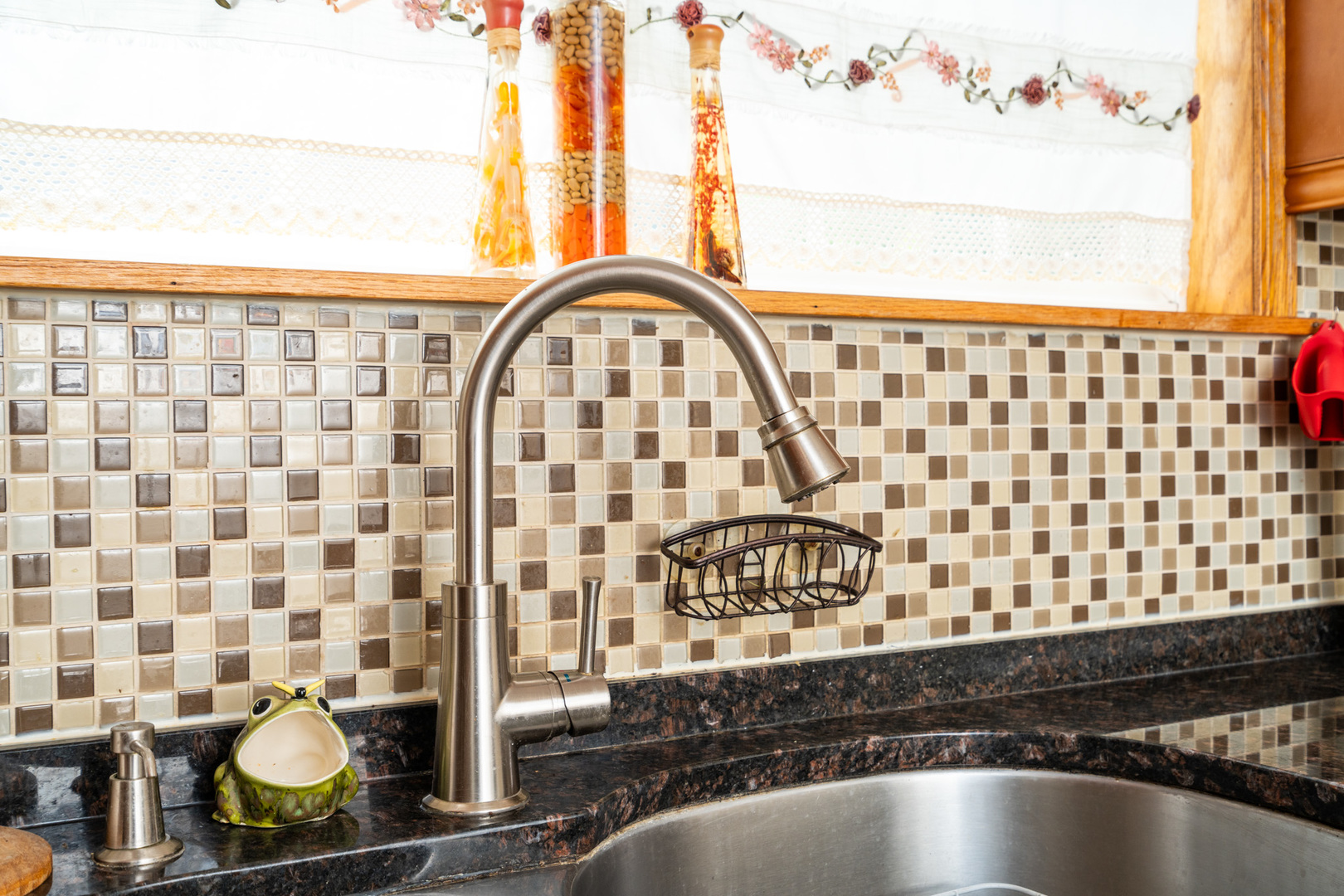 7722 Rutherford Avenue Burbank, IL 60459 - Photo 8 of 31 a close view of a sink a stove and a shower curtain