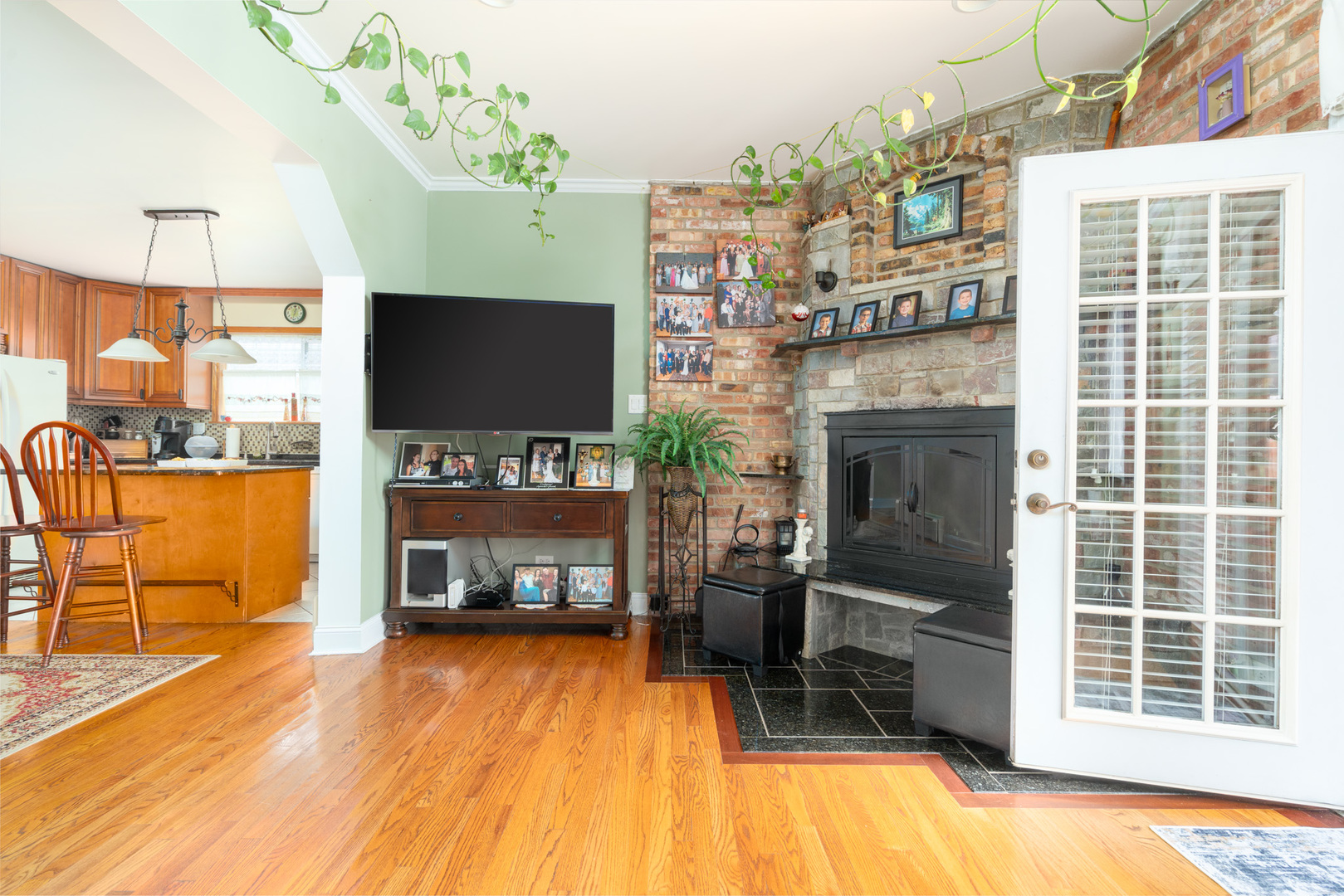 7722 Rutherford Avenue Burbank, IL 60459 - Photo 10 of 31 a living room with furniture a flat screen tv and a fireplace