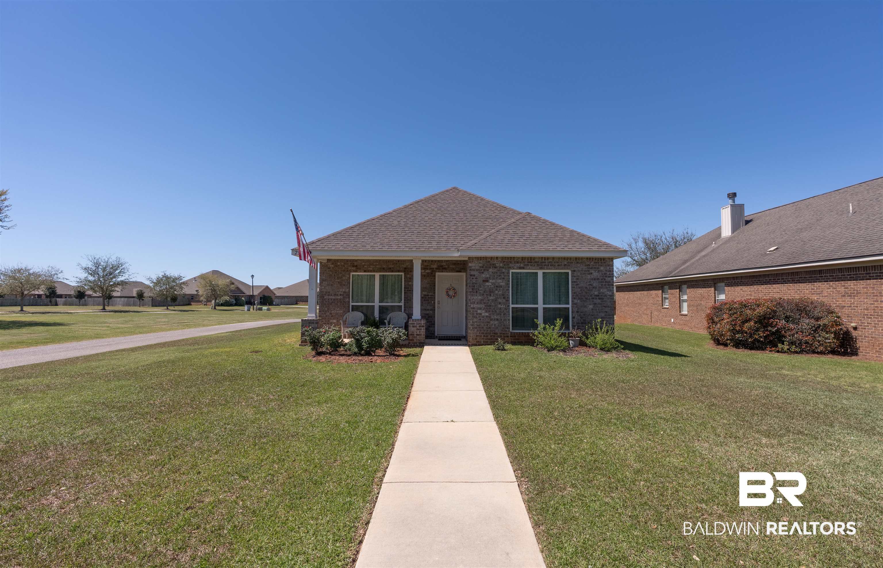 23809 Devonfield Lane Daphne, AL 36526 - Photo 5 of 29 Bungalow featuring a front yard, brick siding, and roof with shingles