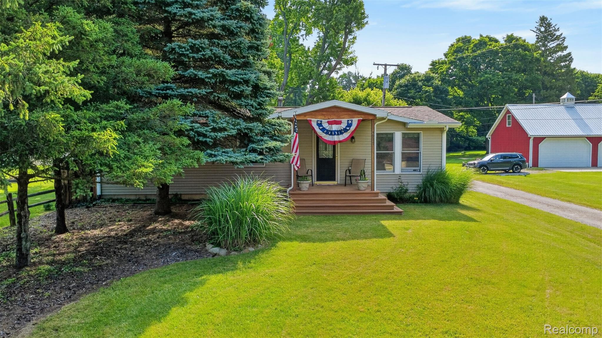 5977 Anglers Road Ortonville, MI 48462 - Photo 38 of 63 Single-story residence featuring light-colored siding and a covered front porch with wood-finish steps