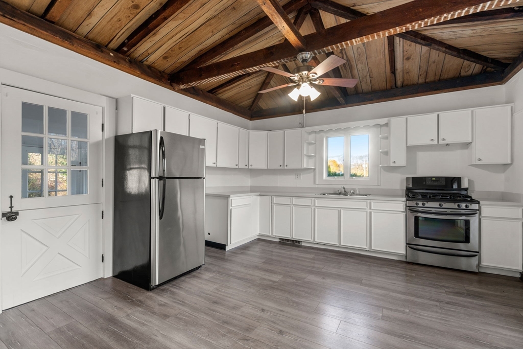 83 Fairhaven Road Mattapoisett, MA 02739 - Photo 12 of 41 a kitchen with stainless steel appliances granite countertop a refrigerator a stove a sink and white cabinets
