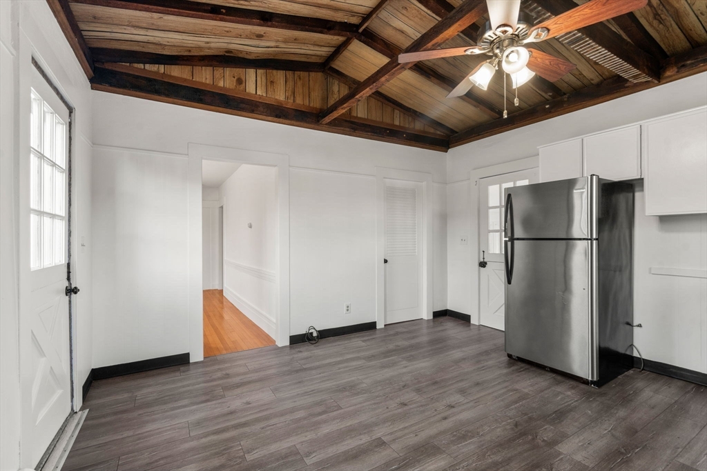 83 Fairhaven Road Mattapoisett, MA 02739 - Photo 13 of 41 a view of an empty room with wooden floor and a kitchen