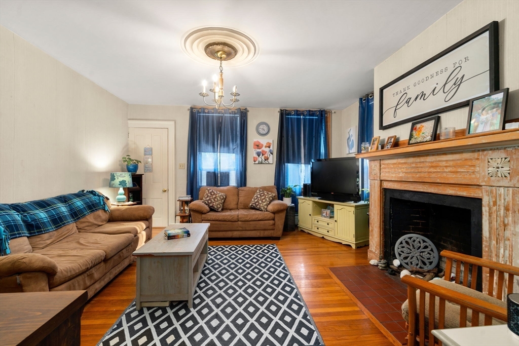 83 Fairhaven Road Mattapoisett, MA 02739 - Photo 3 of 41 a living room with furniture and a fireplace