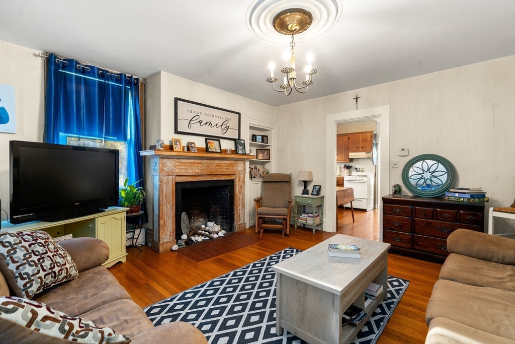 83 Fairhaven Road Mattapoisett, MA 02739 - Photo 4 of 41 a living room with furniture a flat screen tv and a fireplace
