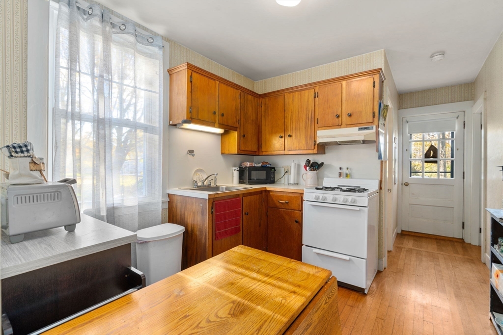 83 Fairhaven Road Mattapoisett, MA 02739 - Photo 5 of 41 a kitchen with a refrigerator and a stove top oven