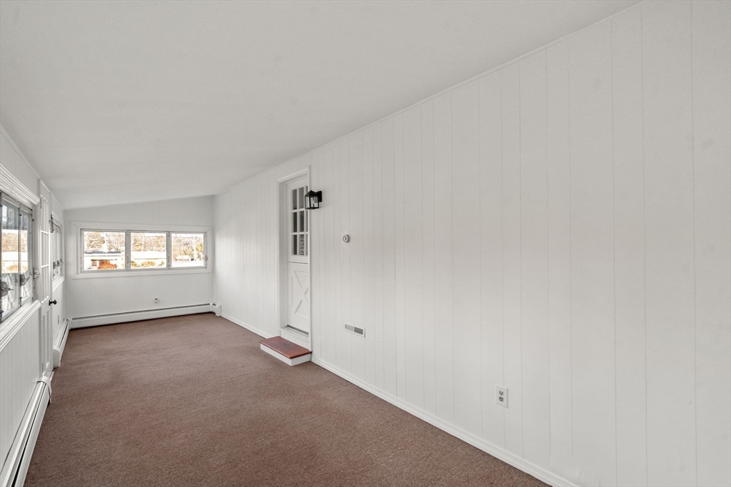 83 Fairhaven Road Mattapoisett, MA 02739 - Photo 10 of 41 a view of an empty room with a window and a kitchen