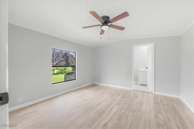 wooden floor in an empty room and a window
