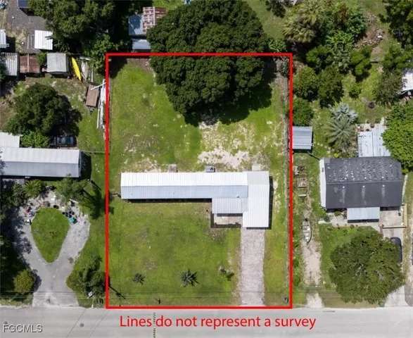 an aerial view of a house with swimming pool and garden