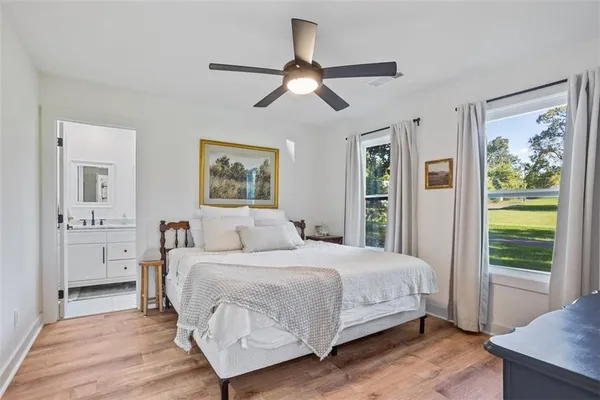 a bedroom with a large bed and a window