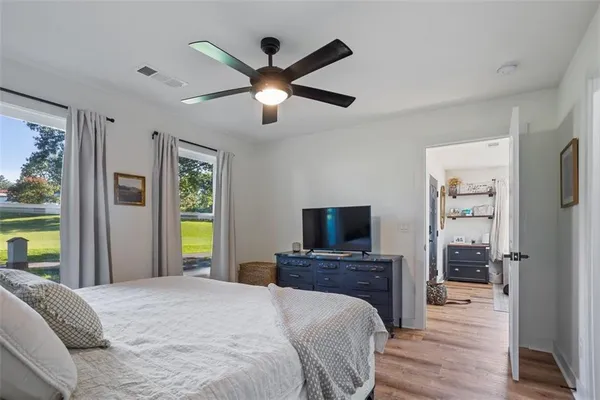 a bedroom with a bed and a flat screen tv