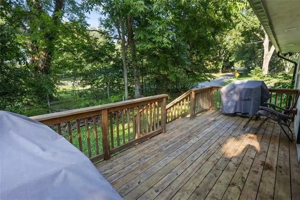 a view of balcony with wooden floor and outdoor seating