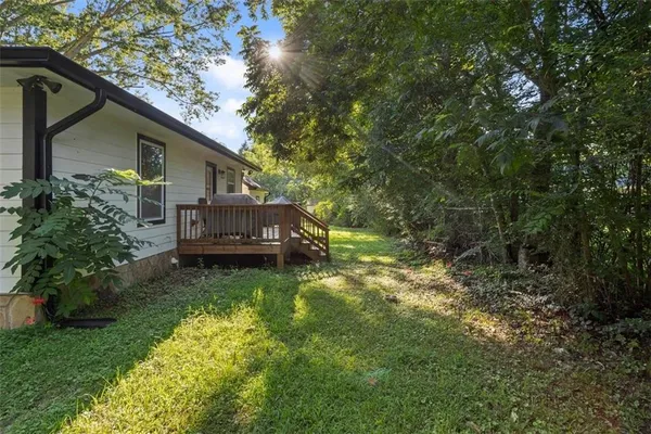 a backyard of a house with yard and trampoline
