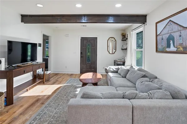 a living room with furniture and a flat screen tv
