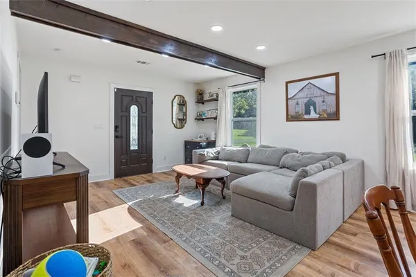 a living room with furniture and wooden floor