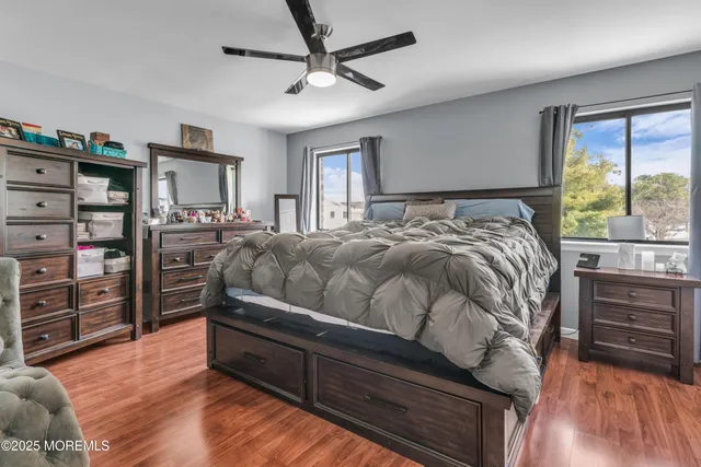 a bathroom with a sink a toilet a mirror and shower