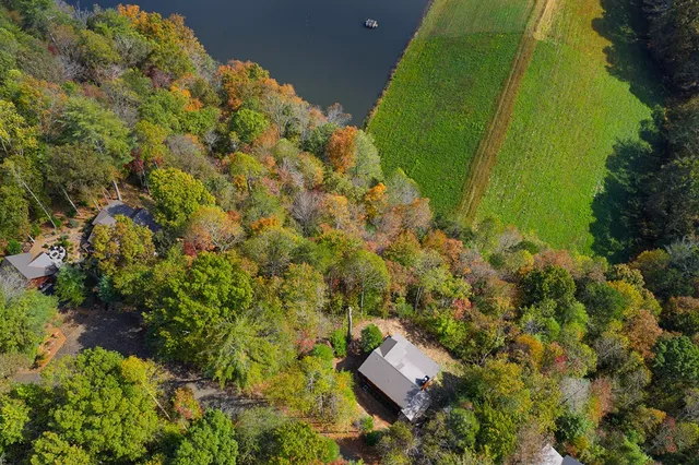 an aerial view of a house with a yard