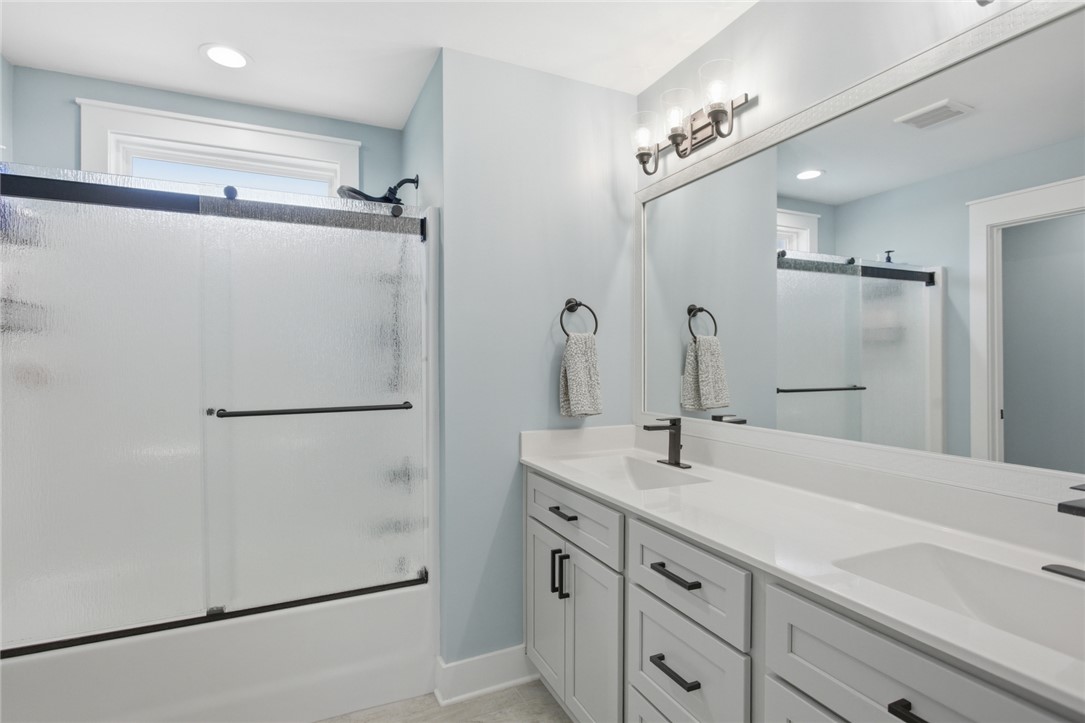 318 Summerall Drive Anderson, SC 29621 - Photo 17 of 42 This bathroom features a sleek vanity and a shower with frosted glass, offering both style and practicality.