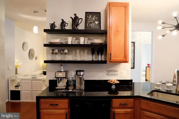 a kitchen with stainless steel appliances granite countertop a sink and cabinets