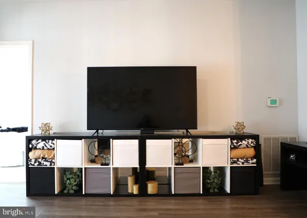 a view of a living room with kitchen countertops and a flat screen tv