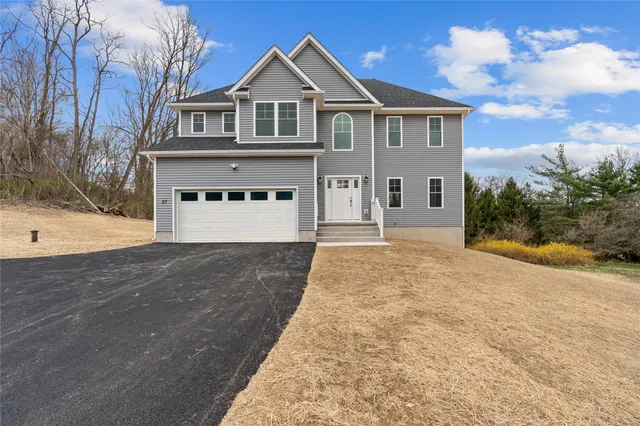 a front view of a house with a yard