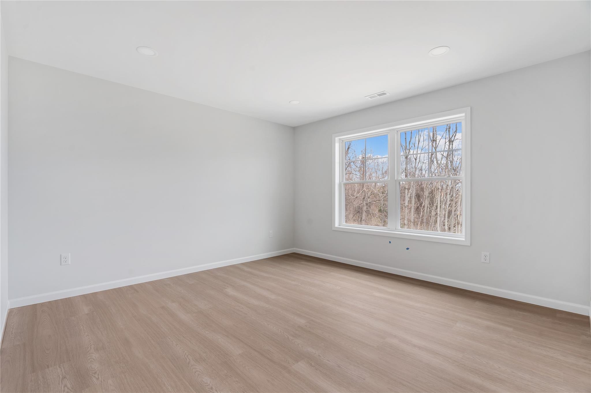 346 Old Hopewell Road Wappingers Falls, NY 12590 - Photo 27 of 42 an empty room with wooden floor and windows