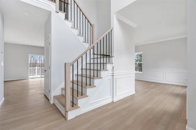 a view of entryway and hall with wooden floor