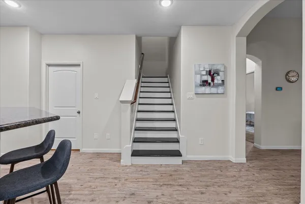 a view of a hallway with stairs and furniture