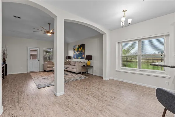 a living room with furniture and a chandelier