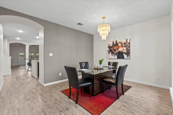 a view of a dining room with furniture wooden floor and a chandelier