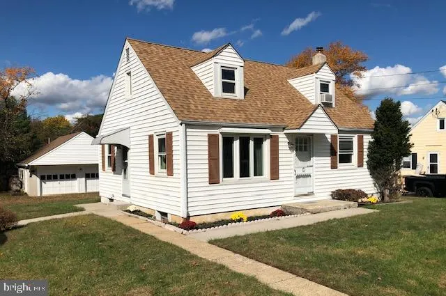 a view of a white house with a yard