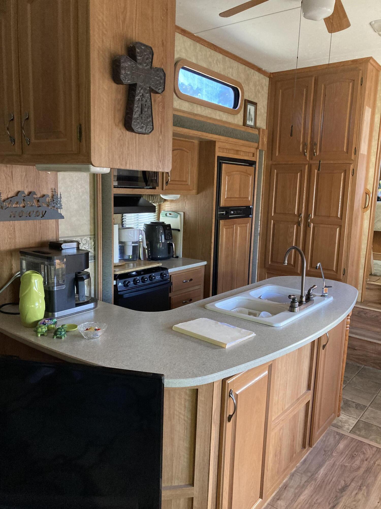 69411 Ramon Road, Unit 61 Cathedral City, CA 92234 - Photo 11 of 14 a kitchen with stainless steel appliances a sink stove and refrigerator