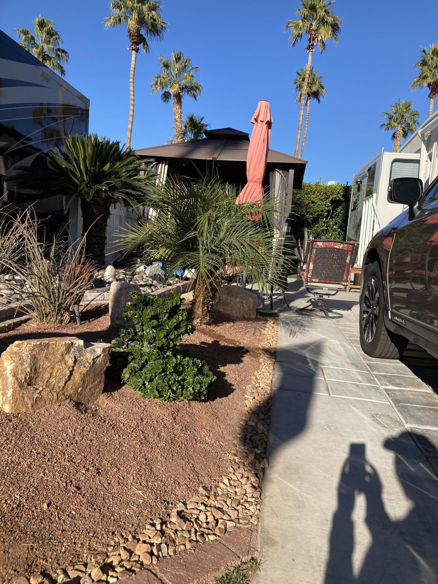 69411 Ramon Road, Unit 61 Cathedral City, CA 92234 - Photo 4 of 14 a front view of a house with a yard