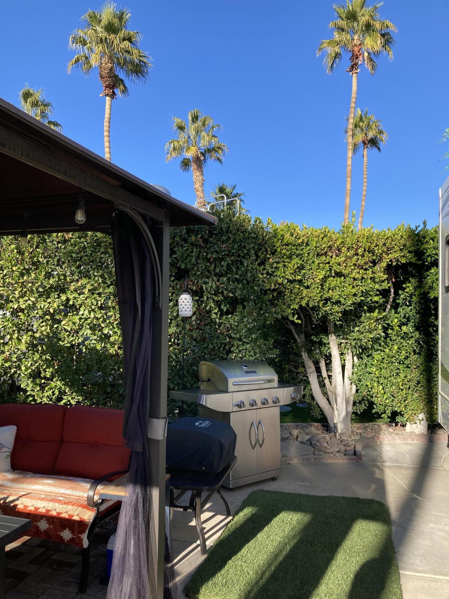 69411 Ramon Road, Unit 61 Cathedral City, CA 92234 - Photo 5 of 14 a view of a porch with a flower garden