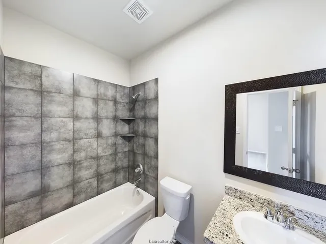 a bathroom with a bathtub and a sink