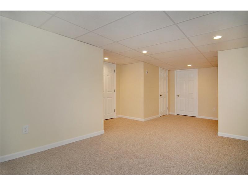 73 Charles Harpin Road Scituate, RI 02825 - Photo 11 of 24 Den/Family/Great Room. The newly finished lower level provides a great space for a family room, media room or recreational room, complete with a nook for an office/desk as well as a new bathroom!!!