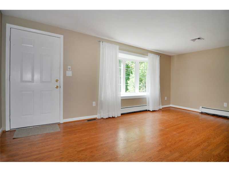 73 Charles Harpin Road Scituate, RI 02825 - Photo 5 of 24 Living Room. Living room has large picture window that provides lots of natural light and views of lovely trees and perennial flowers.