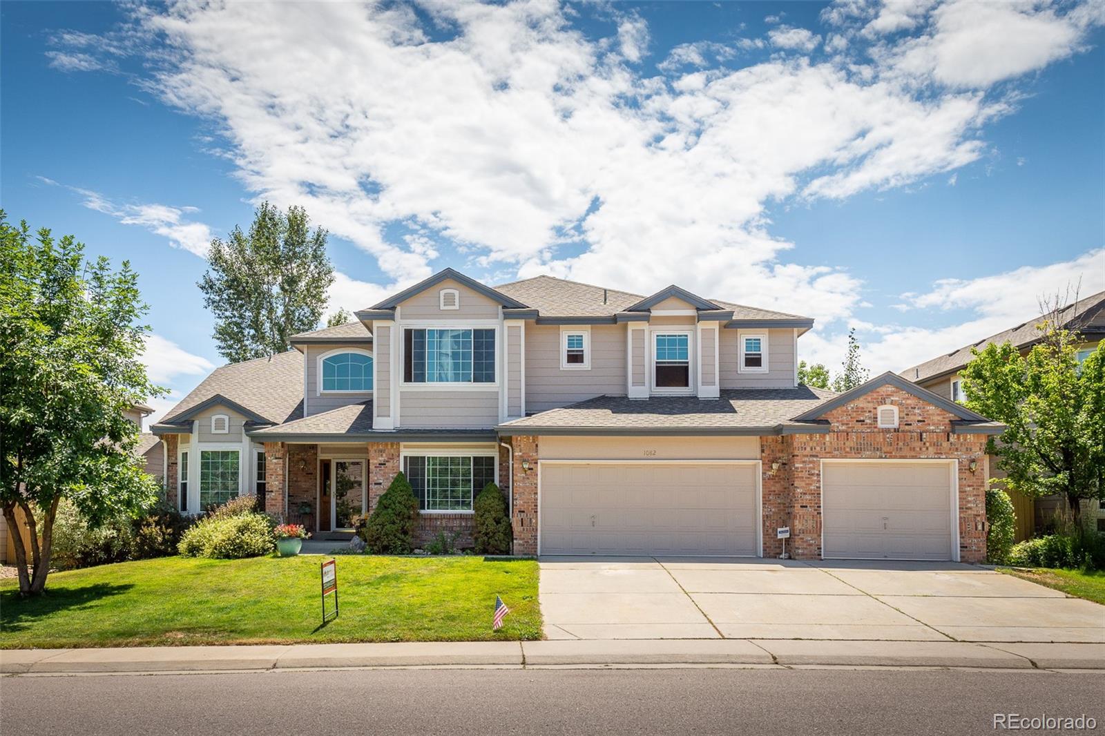 1082 Eldorado Drive Superior, CO 80027 - Photo 1 of 40 a front view of a house with a garden and yard