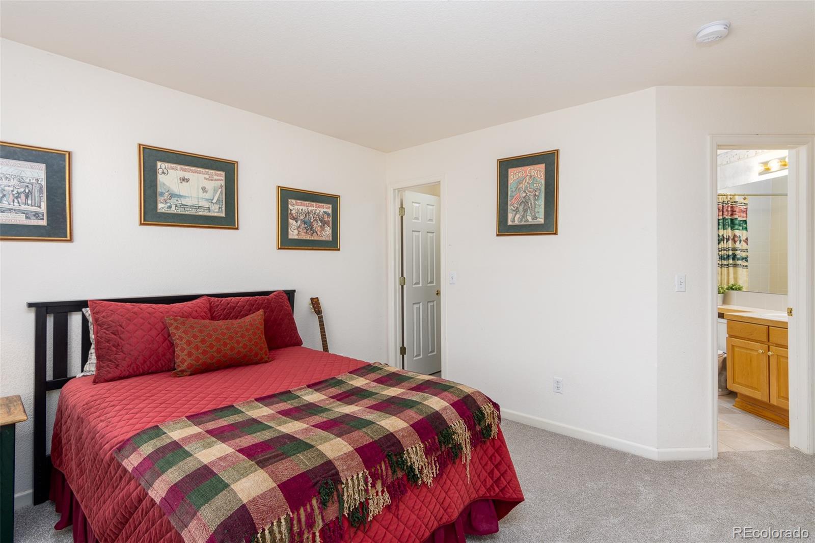 1082 Eldorado Drive Superior, CO 80027 - Photo 24 of 40 a bedroom with a bed and painting on the wall