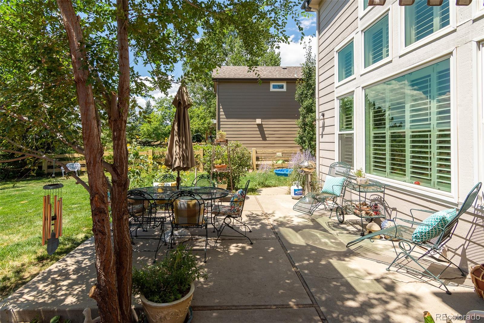 1082 Eldorado Drive Superior, CO 80027 - Photo 33 of 40 a view of a back yard of the house with a chairs and table in the patio